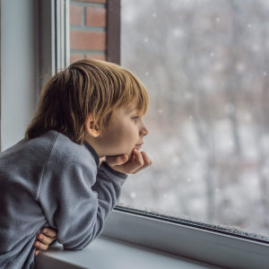 child looks out of window
